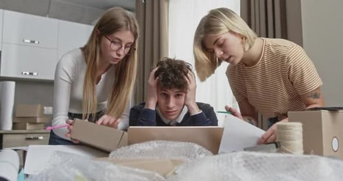 Stressed Young Startup Team Solving Issues with Order Fulfillment