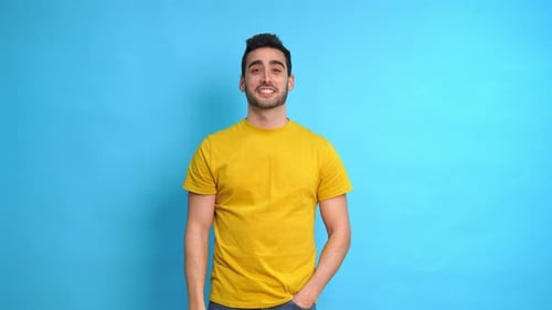 Cheerful Man Showing Thumbs Up and Pointing with Fingers