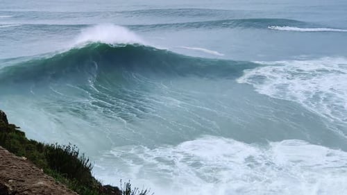 Big giant waves crashing in Nazare, Portugal in the ocean. Biggest waves in the world.