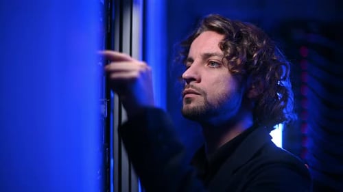 Man analysing servers in a data center