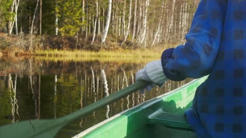 person out canoeing in the sunshine during fall