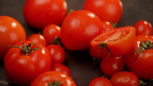A Whole Juicy Fleshy Tomato Falls and Splits in Half