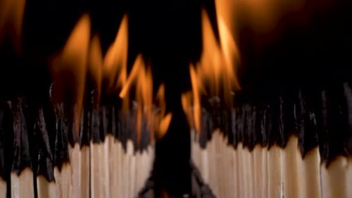 view flying through burning match sticks as they burn down and turn off, shot on probe lens, amazing