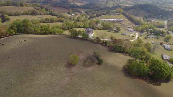 Aerial orbit over Tennesee rural landscape with fields and farms in ...