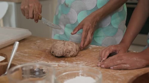 Closeup of Diving Chocolate Dough into Four Pieces with Knife