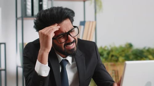 Tired Indian Business Man Suffering From Headache Problem Tension Migraine Stress at Home Office