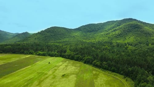 Aerial video view from drone on natural landscape mountain pass under blue sky and clouds. Rural co