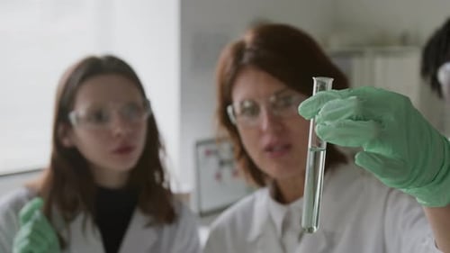 Scientists Examining Sample in Test Tube