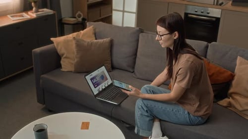 Woman Shopping Online at Home on Laptop and Phone