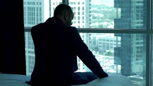 Tired Businessman Resting on Bed in Hotel Room Adult