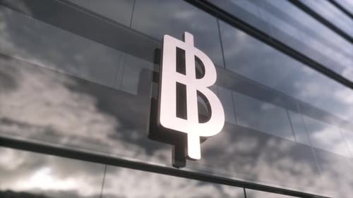 Thai Baht Currency Sign on a Modern Glass Skyscraper