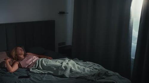 Woman Waking Up and Stretching in Bedroom