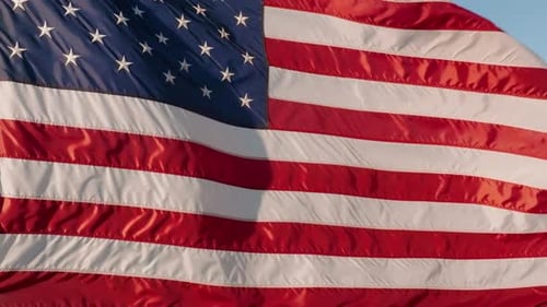 American Flag Waving Proudly in the Blue Sky