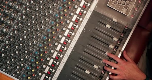 Studio, hand and person with music mixer for volume level, frequency change and control