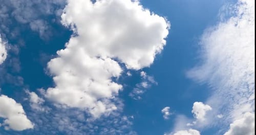Light airy soft clouds in the beautiful azure sky. Cloudscape moved by the wind in the atmosphere.