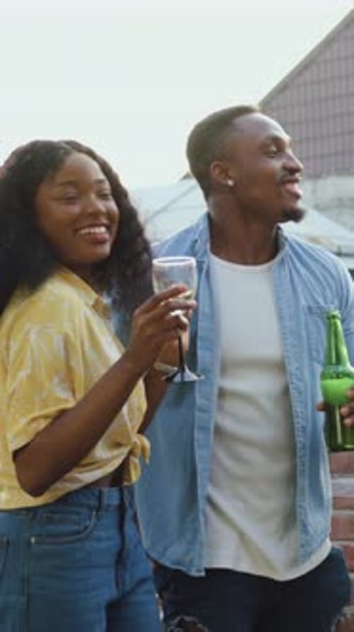 Friends toasting each other with beer and champagne