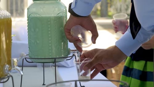 Refreshing Beverage Poured from Dispenser at Event