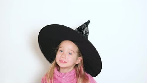 Smiling Girl Wearing Witch Hat Indoors