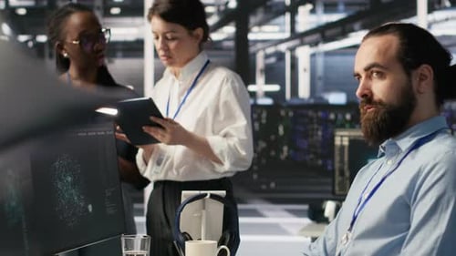 Software Developers Working Together in Server Farm Reviewing AI Code