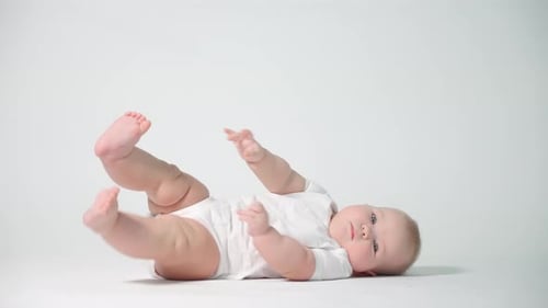 Adorable Infant Lying on Back and Tummy