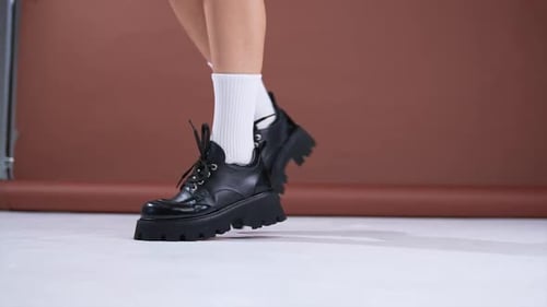 Close Up of Legs Wearing Black Platform Shoes