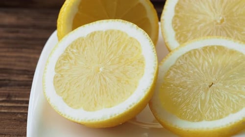Sliced Lemons Displayed on White Plate