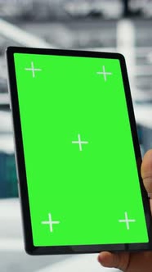 Vertical Video Close Up of Admin in Data Center Using Green Screen Tablet