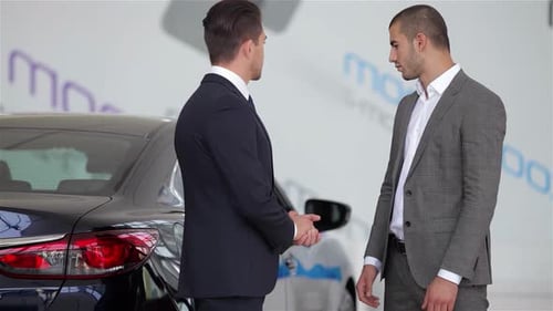 Businessmen Conclude Deal in Car Dealership