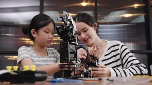 Children Building a Robotics Arm in Classroom