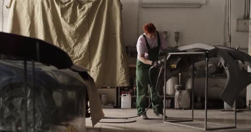 Female Painter Working in Sunlit Garage