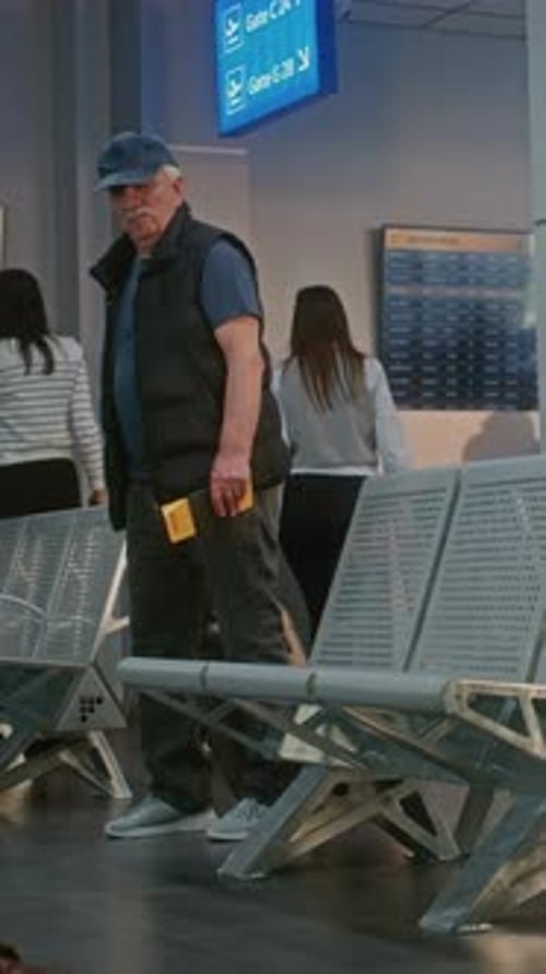 Airport Terminal Senior Man with Suitcase Documents and Boarding Pass Sitting in Departure Lounge