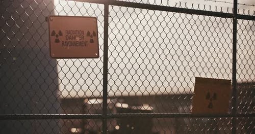 Rusty Fence with Radiation Warning Signs