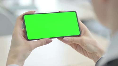 Close Up of Hands Holding Smartphone with Green Screen
