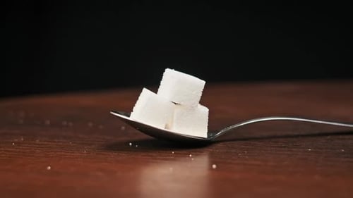 Sugar Cubes Stacked on Spoon