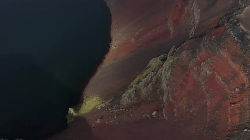 Aerial tilt up shot extreme crater with lake named Ljotipollur in Iceland