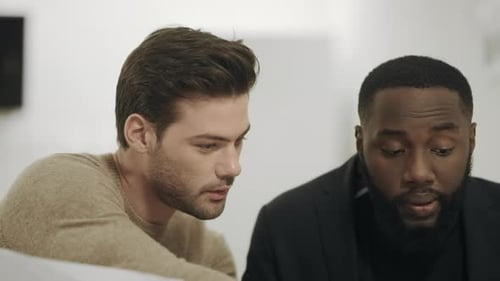 Two Colleagues Analyzing Working Data Together. Young Workers Comparing Information In Office. Su...