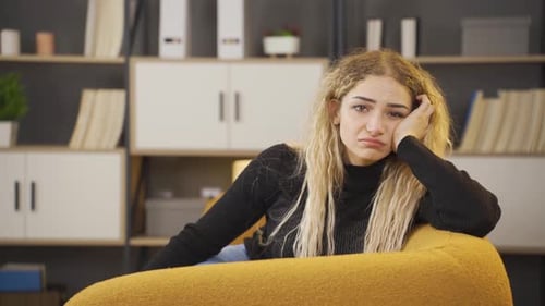 Sad Young Woman Looking at Camera