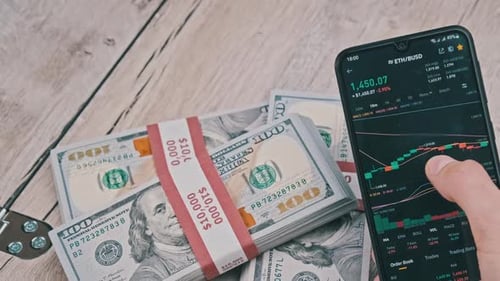 Trader Analyzes Ethereum Cryptocurrency Prices on Smartphone Above Dollars