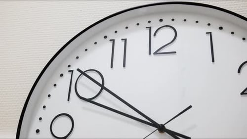 Analog wall clock hands moving in fast motion