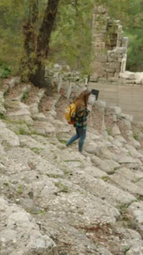 Woman Exploring Ancient Ruins on Sunny Day