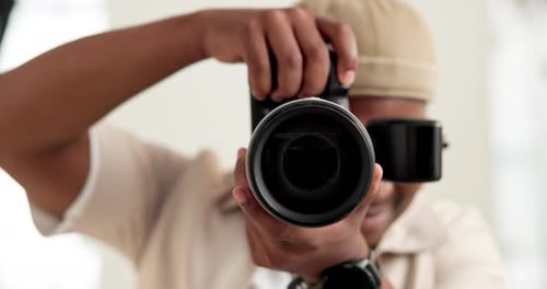 Man, photographer and lens of camera in studio for production, photoshoot and capture picture