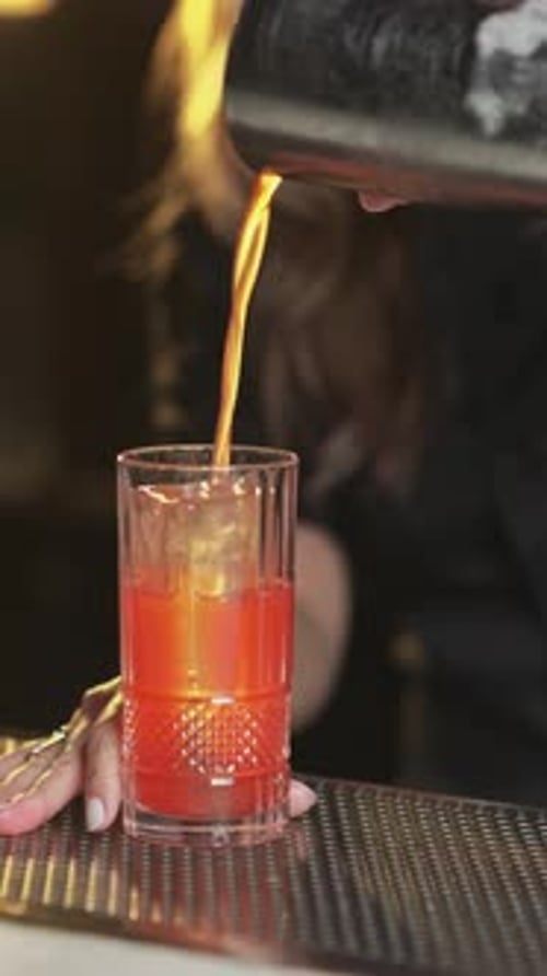Bartender Preparing a Mixed Drink in a Glass