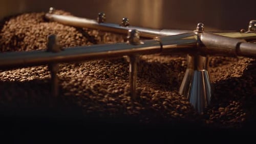 Close Up Coffee Roasting Process with Metal Arms