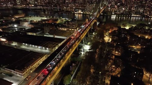 Cars Traverse Illuminated Queensboro Bridge Linking Manhattan and Queens in New York City Vibrant