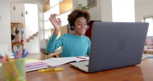 Happy Child Waving During Online Lesson