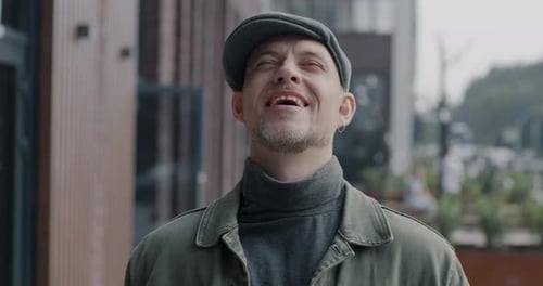 Smiling Man Outdoors in Gray Cap and Jacket