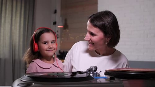 Child and Woman Listening to Music on Record Player