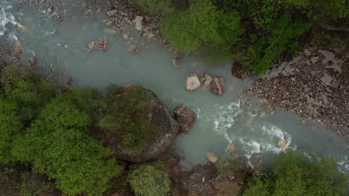 Aerial Shot of Mountain River Meandering through Forested Landscape