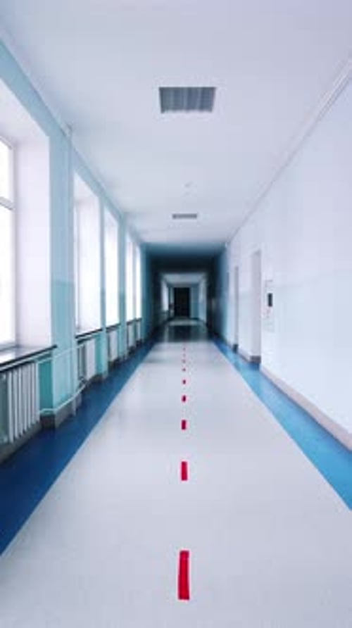 Motion along the corridor inside empty college.