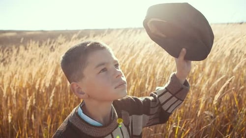 Simple Village Boy in a Field Watching Over the Air